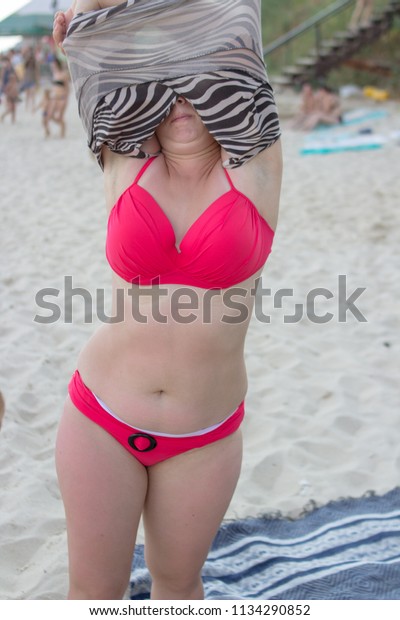 donald choi add girl strips at beach photo